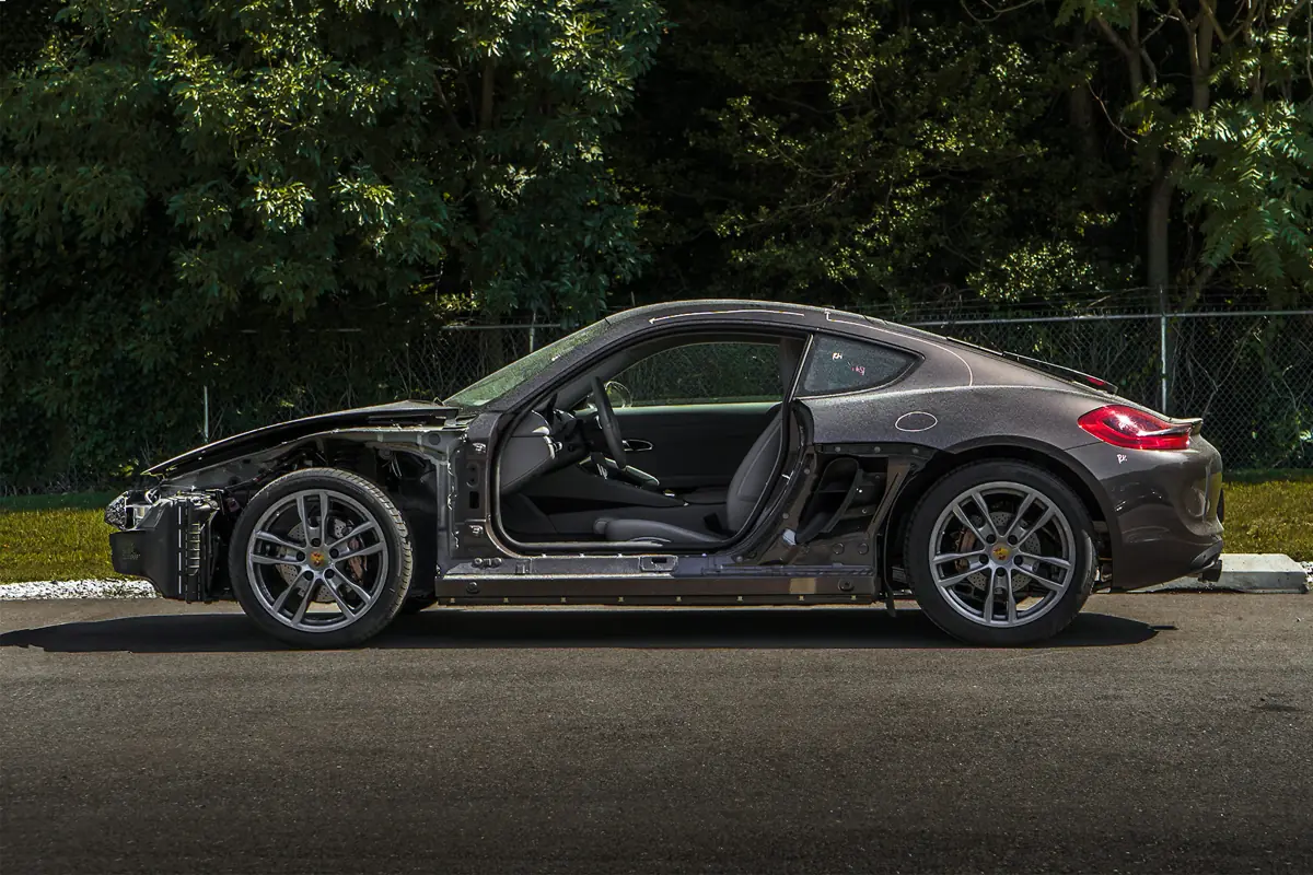 Porsche Cayman taken apart for collision repair at Moppert Auto Collision