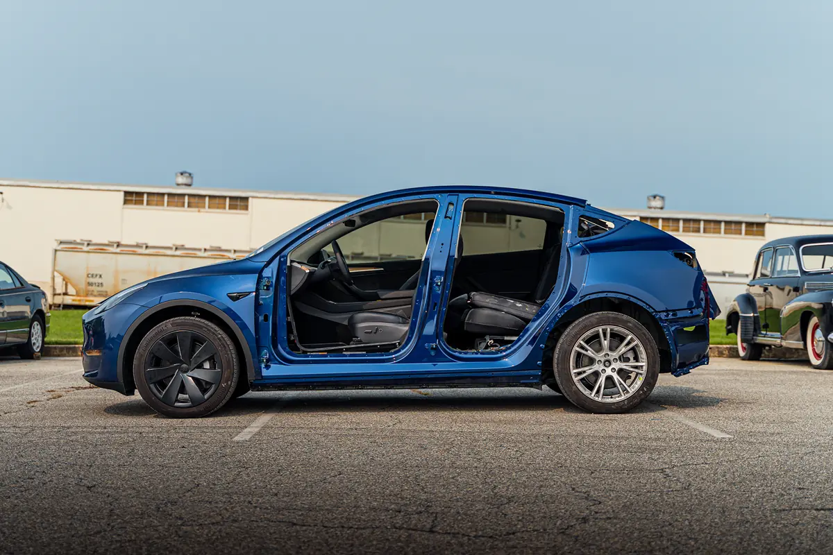 Tesla with doors open in the Moppert Auto Collision shop