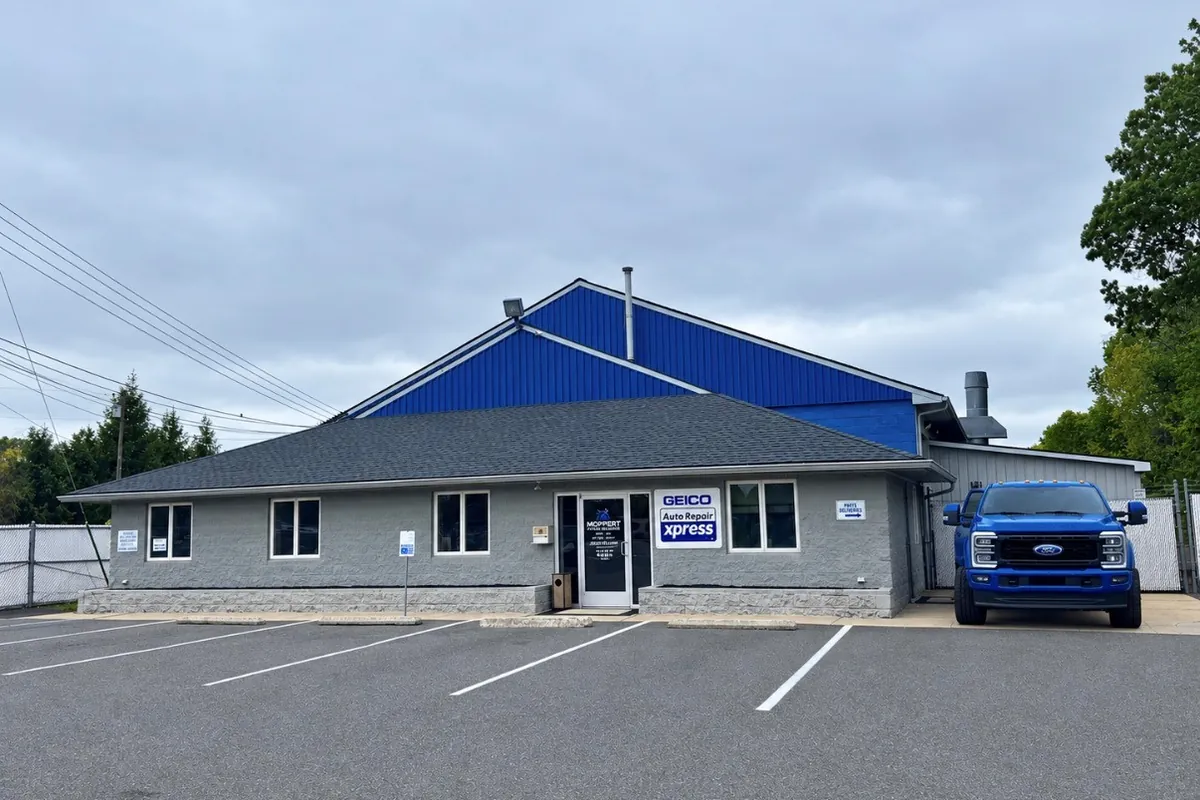 Moppert Auto Collision on Route 42 in Turnersville, NJ, with the GEICO Auto Repair Xpress sign at the entrance