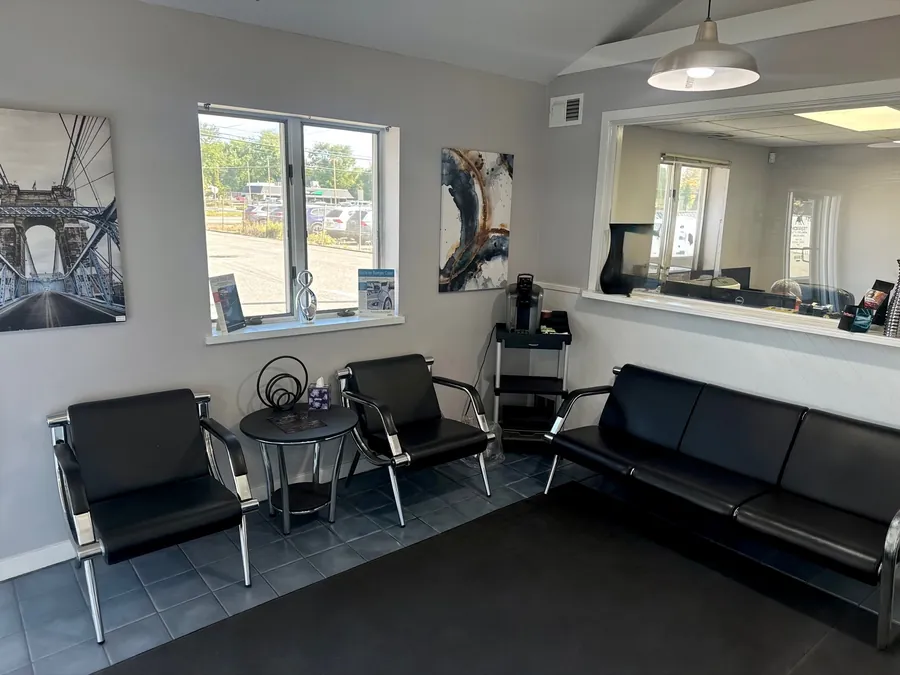 Customer waiting area with seating and a coffee station at the Turnersville shop